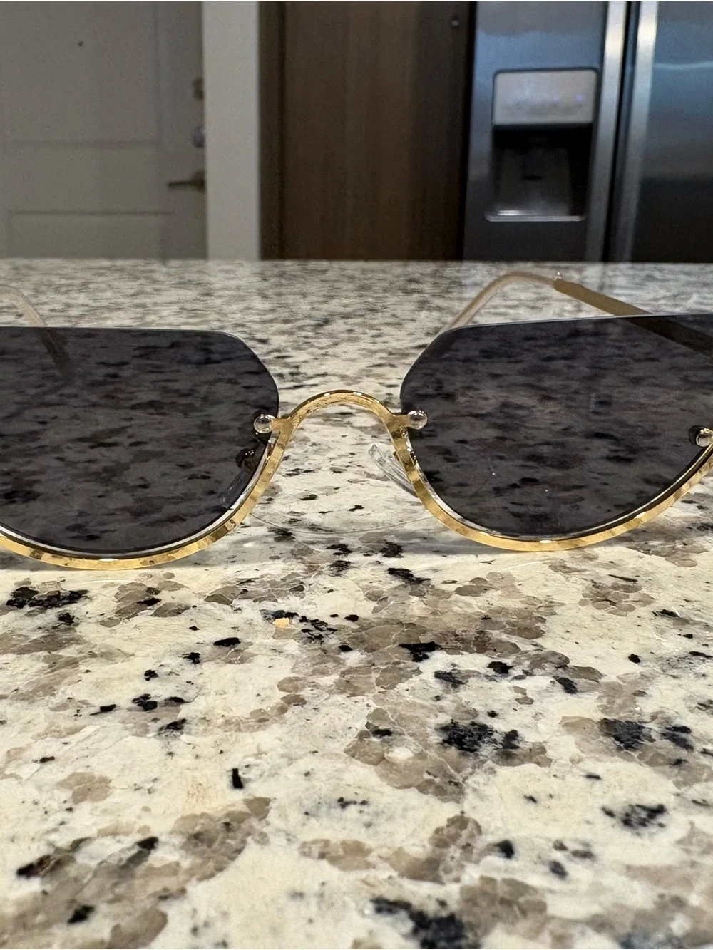 Gold rimmed sunglasses